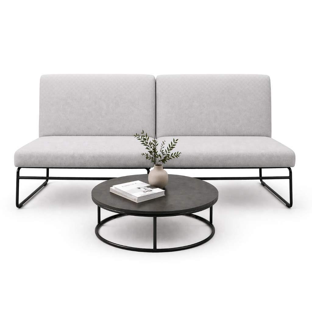 Gray sofa with a round coffee table featuring a vase and books on a white background