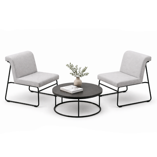 Two modern chairs with a round coffee table on a white background