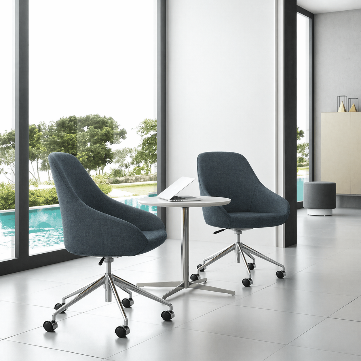 Two modern blue office chairs with a small round table in a bright room with large windows.